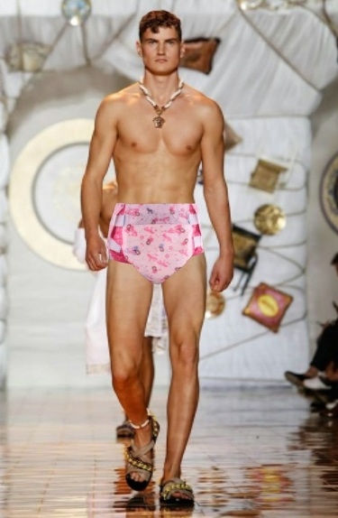 Men's Funny Fashion Show. (Bonus Image Added) - A male model gets roped into wearing and displaying a pink adult disposable nappy on a catwalk., sissy adult baby fashion,sissy adult baby caption, Adult Babies,Diaper Lovers,Sissy Fashion